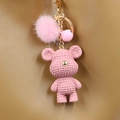 Handmade pink crochet bear keychain with fluffy pompom and bell on leather background - Pink Bear