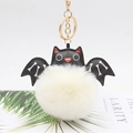 Cute Halloween bat pompom keychain with white faux fur ball and black leather wings - Off White