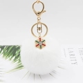 White faux fur pom pom keychain with a colorful rhinestone snowflake charm and gold clasp - White