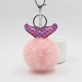 Close-up of pink faux fur ball keychain with iridescent purple fish tail and silver clasp - Pink