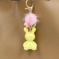Iridescent yellow bunny keychain with pink fur pom pom detail on a brown leather bag - Yellow Rabbit