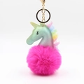 Detailed close-up of gradient unicorn plush keychain with fluffy pink ball and gold ring - Rose Red