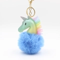 Macro shot of fluffy blue faux fur unicorn keychain with rainbow mesh and golden hardware - Blue