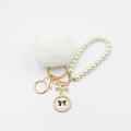 Detailed macro view of white faux fur pompom with pearl chain and golden bow charm - Pom Pom Diameter 6CM / White