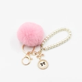 Close-up of pink fluffy fur pompom with pearl strap and gold clasp bag accessory - Pom Pom Diameter 6CM / Water Pink