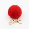 Nahaufnahme des roten Pelzimitat-Bommel-Schlüsselanhängers mit goldenem Karabinerhaken - Rot