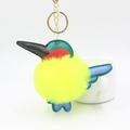 Detail of colorful plush hummingbird keychain with faux fur ball and gold metal ring - Yellow