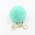 Detail of mint green faux fur pompom keychain with golden lobster clasp and crystal cage - Light Green