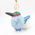 Detail of kingfisher plush pompom keychain with colorful leather patches and gold clip - Haze Blue