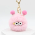 Cute pink plush monster keychain with large eyes and soft fur on a white pedestal - Pink