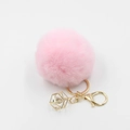 Detailed close-up of pink faux fur pompom keychain with golden crystal drop pendant - Light Pink