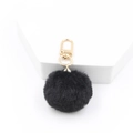 Close-up of 4cm black plush faux fur pompom keychain with a gold-tone lobster clasp - Black
