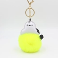 Detail of penguin plush keychain with gold lobster clasp and bright yellow faux fur ball - Yellow