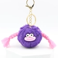 Close-up of cute purple fluffy ball keychain with pink big lips and braided pigtails detail - Bright Purple