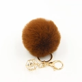 Detail of fluffy brown faux fur pom pom keychain with gold geometric rhinestone frame - Brown