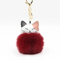 Close-up of cute cartoon cat head faux leather charm with fluffy burgundy pompom and gold clip - Burgundy