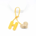 Detail showing high-quality PU leather letter H and beige heart keychain charm - Khaki And Yellow