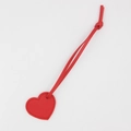 Close-up of red heart-shaped leather keychain with stitching details and matching strap - Red
