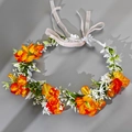 Close-up of artificial orange and yellow floral wreath with white flowers and ivory ribbon - Orange