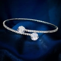 Macro shot of silver-tone open cuff bracelet with pavé rhinestones on blue satin - Round Cut Style (BS-J5417YX)