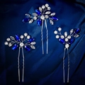 Gros plan détaillé de trois épingles à cheveux en strass bleu roi sur tissu en soie - Épingles à Cheveux en U Strass Bleu 3 Pièces (HS-J6405SBLUE)