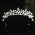 Elegant silver crown featuring white pearls and sparkling rhinestones on a dark background - Vintage Leaf Pearl Crown (TS-J2662)