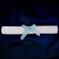 White bridal garter with blue satin bow and pearl accent on dark silk background - One Size / GS-J034 Style