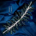 Detail of luxury emerald rhinestone bridal headband and matching clips on blue silk - Green