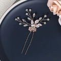 Detailed macro view of a rose gold bridal hair pin with crystal rhinestones and metal leaves - Rose Gold Floral Hair Pin (HS-J4794RG)