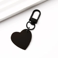 Detail view of a matte black heart-shaped metal keychain with a large D-ring lobster clasp - Slanted Heart / 30x28.5mm / Black