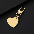 Polished gold heart shaped metal keychain with lobster clasp on a dark background - Slanted Heart / 30x28.5mm / Gold