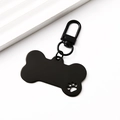 Macro detail of bone-shaped black metal pet tag with hollow paw print and lobster clasp - Large Bone (Hollow Paw) 34mm Clasp / Black