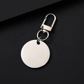 Macro view of blank silver metal round pendant keychain with lobster clasp on dark background - 25mm Inner Round Silver + 34mm Silver Door Buckle