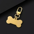 Polished gold bone-shaped pet tag with a rotating spring lobster clasp and metal rings - Gold Bone Shape Clip