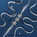 Detail shot of crystal flower bridal belt with size specs on blue texture background - Silver