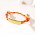 Adjustable woven rope bracelet with gold metal plate in vibrant red yellow and orange - Red Yellow Rope / Gold Metal Plate