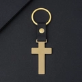 Minimalist golden metal cross keychain with black leather strap and textured backdrop - Gold Cross