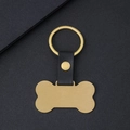 Placa para mascota en forma de hueso dorado con correa de cuero negro y acabado mate - Dorado