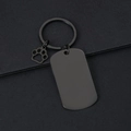 Close-up of black matte stainless steel keychain with dog paw charm and blank tag - 50x28mm Military Tag Black