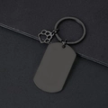 Close-up of black matte stainless steel key ring with hollow paw print charm detail - 49x28mm Military Tag Black