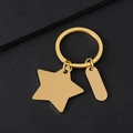 Polierter goldener Schlüsselanhänger aus Edelstahl mit Stern und Oval auf schwarzem Grund - Gold-Stil