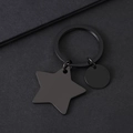 Detail shot of matte black stainless steel keychain with star and round pendants - Black Star Circle Keychain