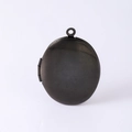 Detail of a black brushed stainless steel oval photo locket with a side hinge and top loop - Black Photo Locket Pendant