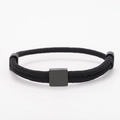 Detail of minimalist black woven cord bracelet featuring a matte metal rectangle charm - Square Charm (Double Buckle) / Black