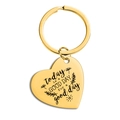 Detail of golden heart-shaped keychain with engraved motivational text on polished metal - Good Day Quote (TX0074) / Gold