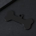 Detail view of bone-shaped pet ID tag with matte black metal finish and round hanging hole - Bone Style / 34.8x16.4mm / Black