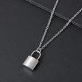 Close-up of polished stainless steel padlock pendant on a classic silver O-link chain - Silver