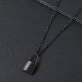 Detail of matte black stainless steel padlock pendant necklace on textured background - Black
