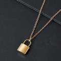 Elegant gold padlock pendant necklace with fine chain displayed on a dark surface - Gold