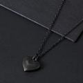 Detalle macro del colgante de corazón negro pulido en una cadena de acero inoxidable - 16.3x16mm Corazón + Cadena de Cruz Plana (45+5cm) / Estilo Negro